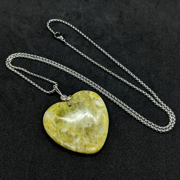 Carved Peridot Heart pendant with sterling silver bail on 24 inch stainless chain